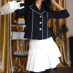 This woman's chic ensemble is completed with a pair of stunning thigh high boots.