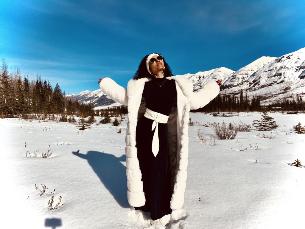 Elegant woman dressed to impress in the middle of the mountains